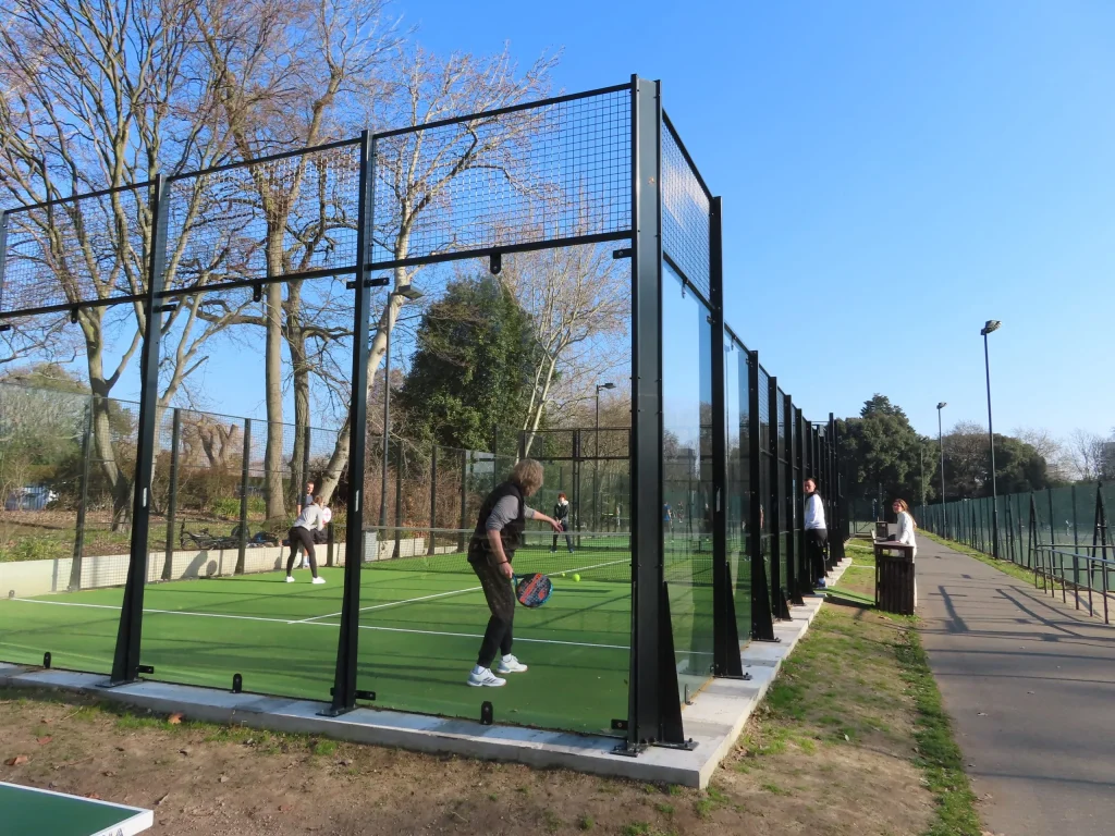 Outdoor padel court with players and glass walls in Regents Park London