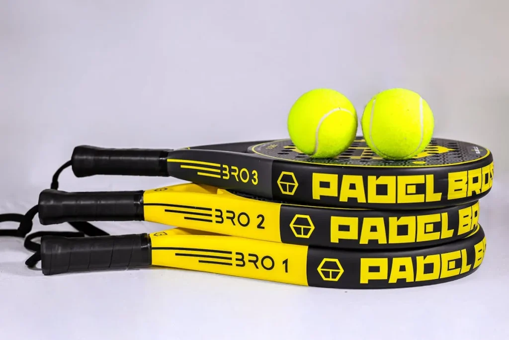 Three Padel Bros rackets with balls on white background