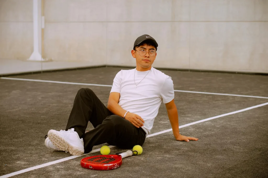 Padel equipment on court with glass wall backdrop