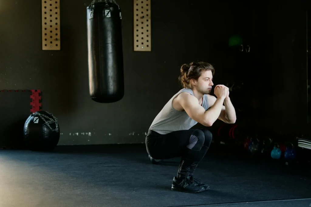 Person performing a squat exercise in a gym