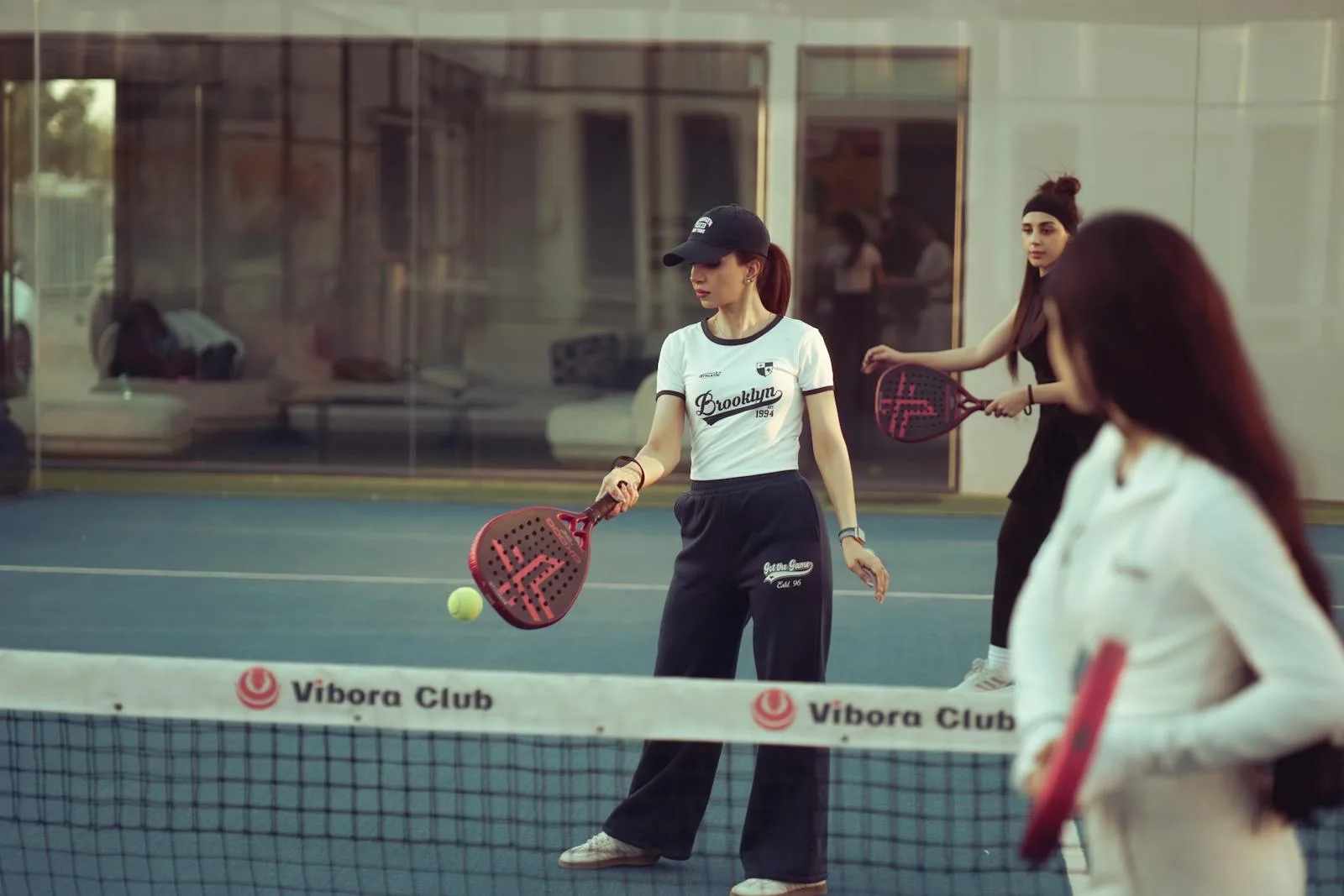 Players during a padel match on an indoor court at a UK padel facility