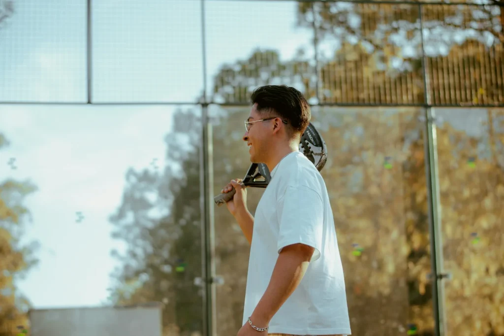 Padel court with glass walls and equipment ready for play — UK padel accessories checklist