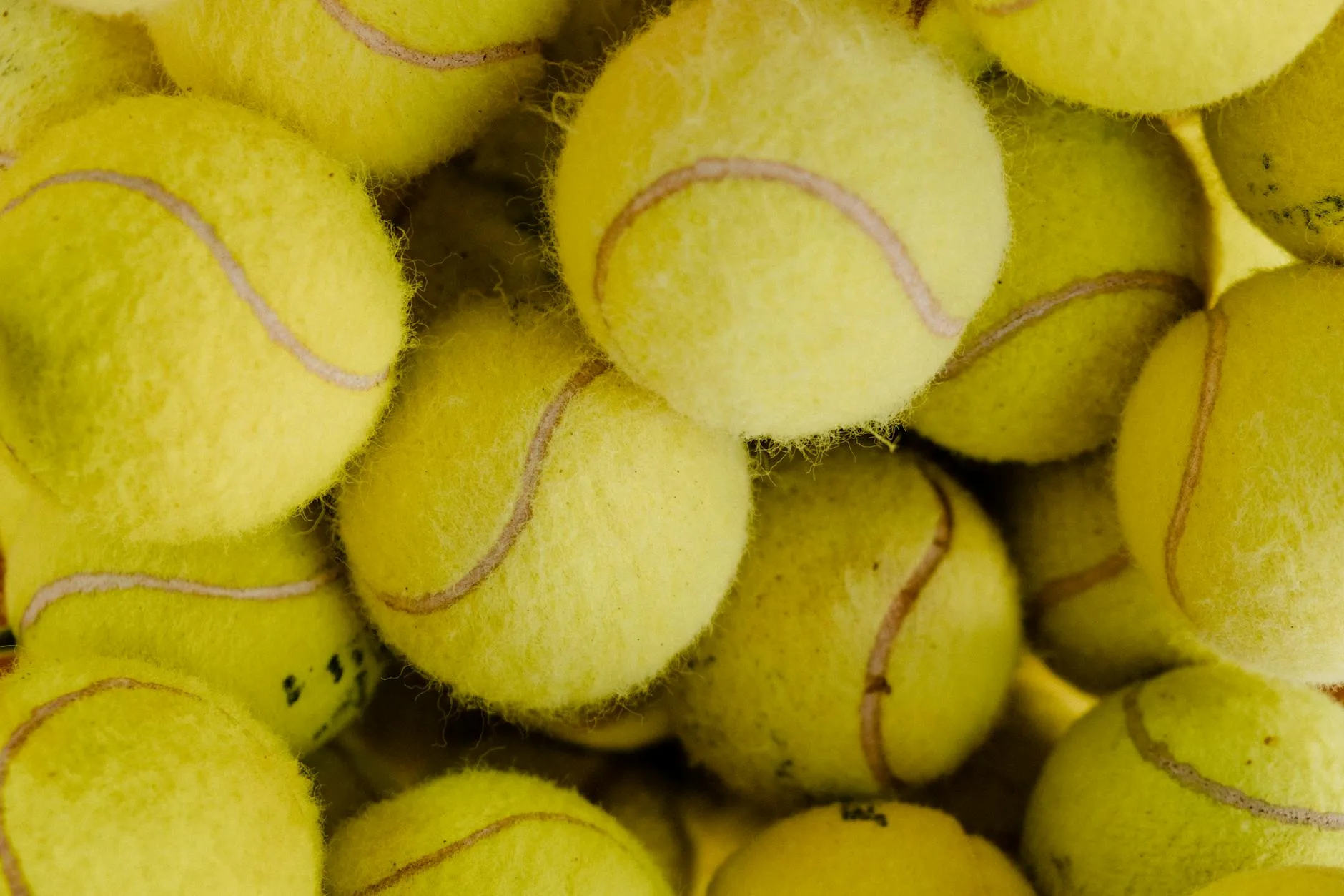 Close-up of used padel balls showing felt and seams