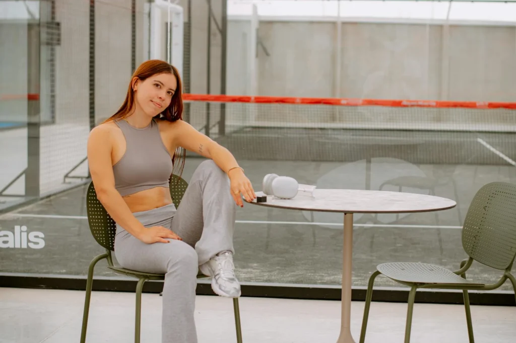 Indoor padel court with glass walls during a doubles match