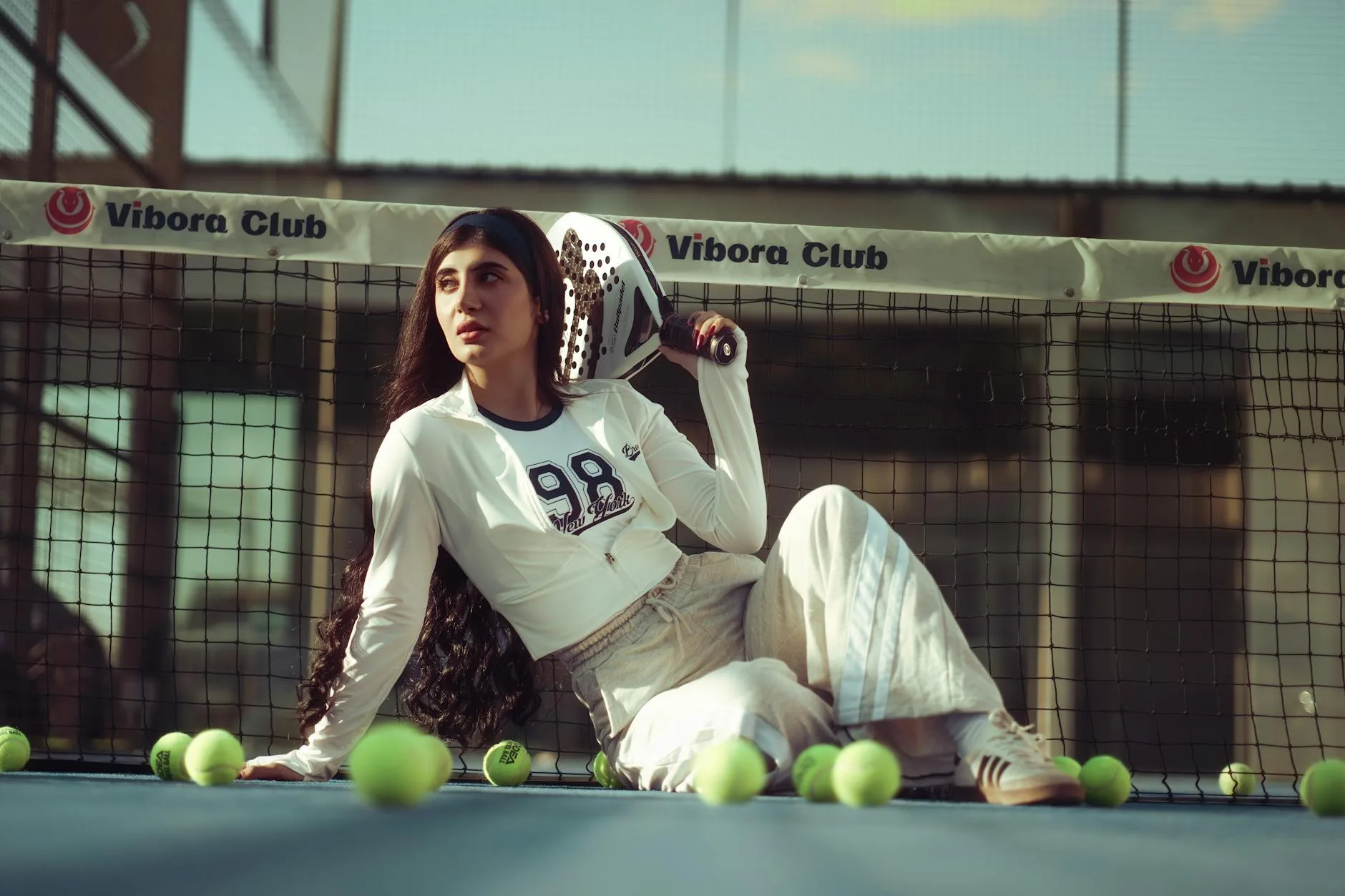 Padel racket and accessories laid out on a court surface