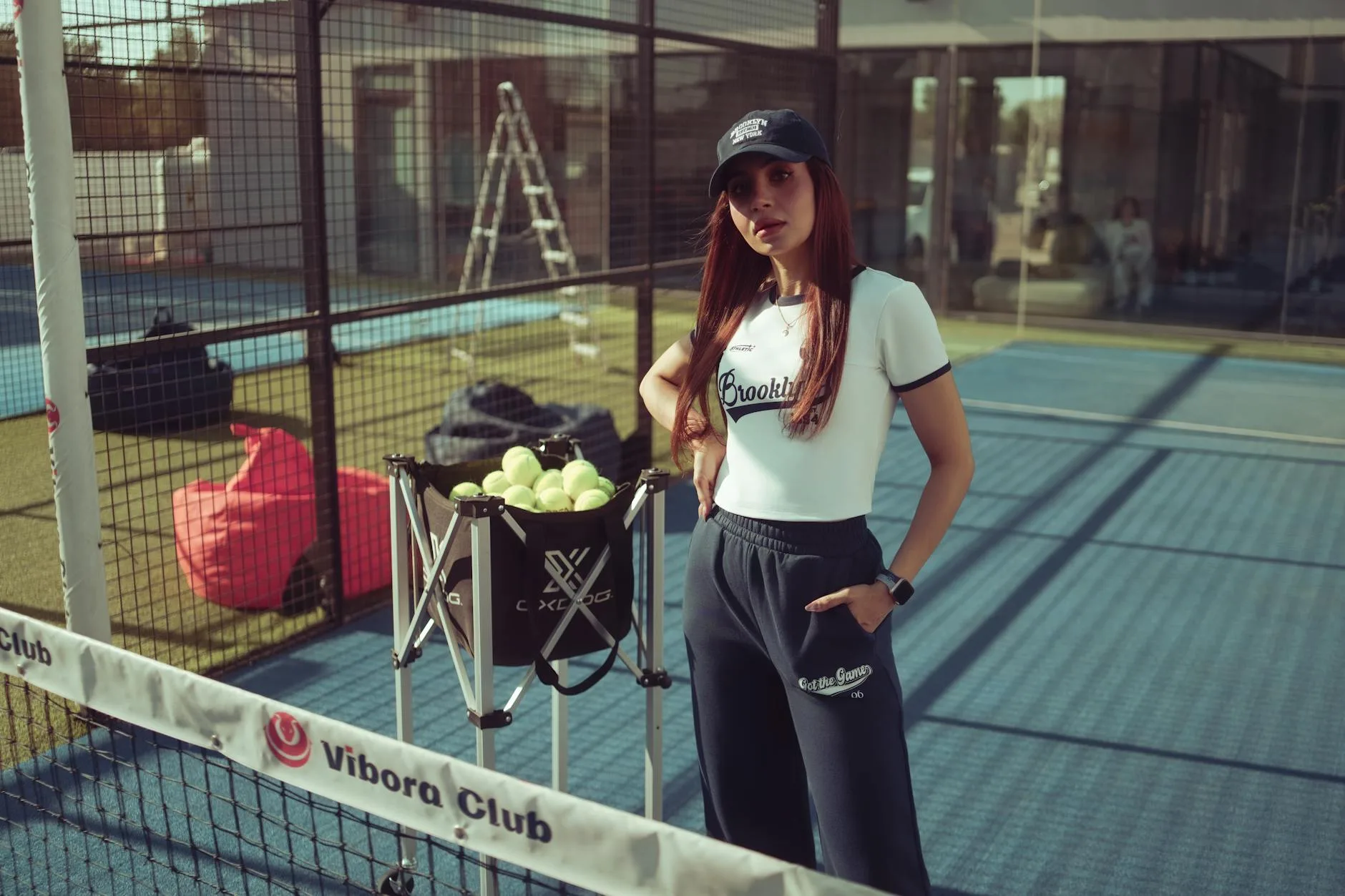 Padel player near the glass wall on an enclosed court