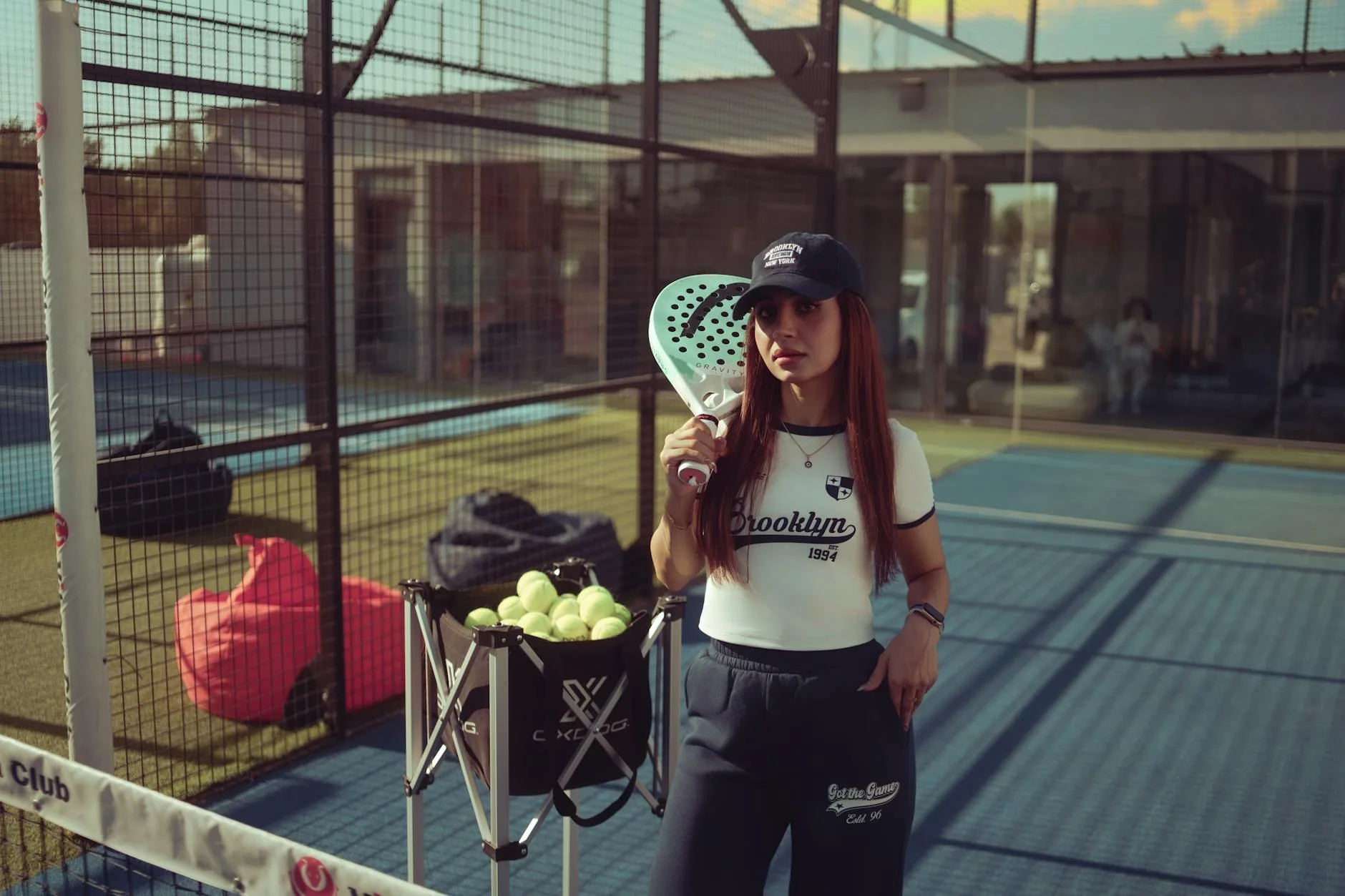 Padel player on court with balls — best padel balls UK