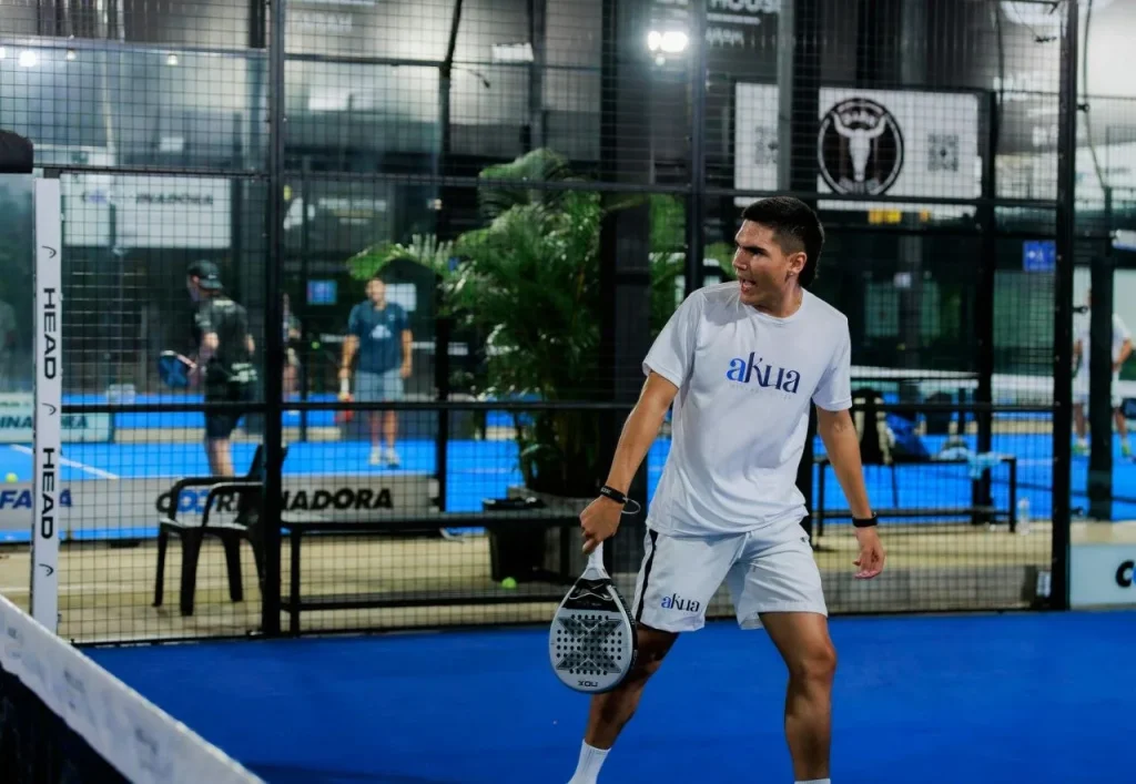 Padel player on court holding racket with overgrip
