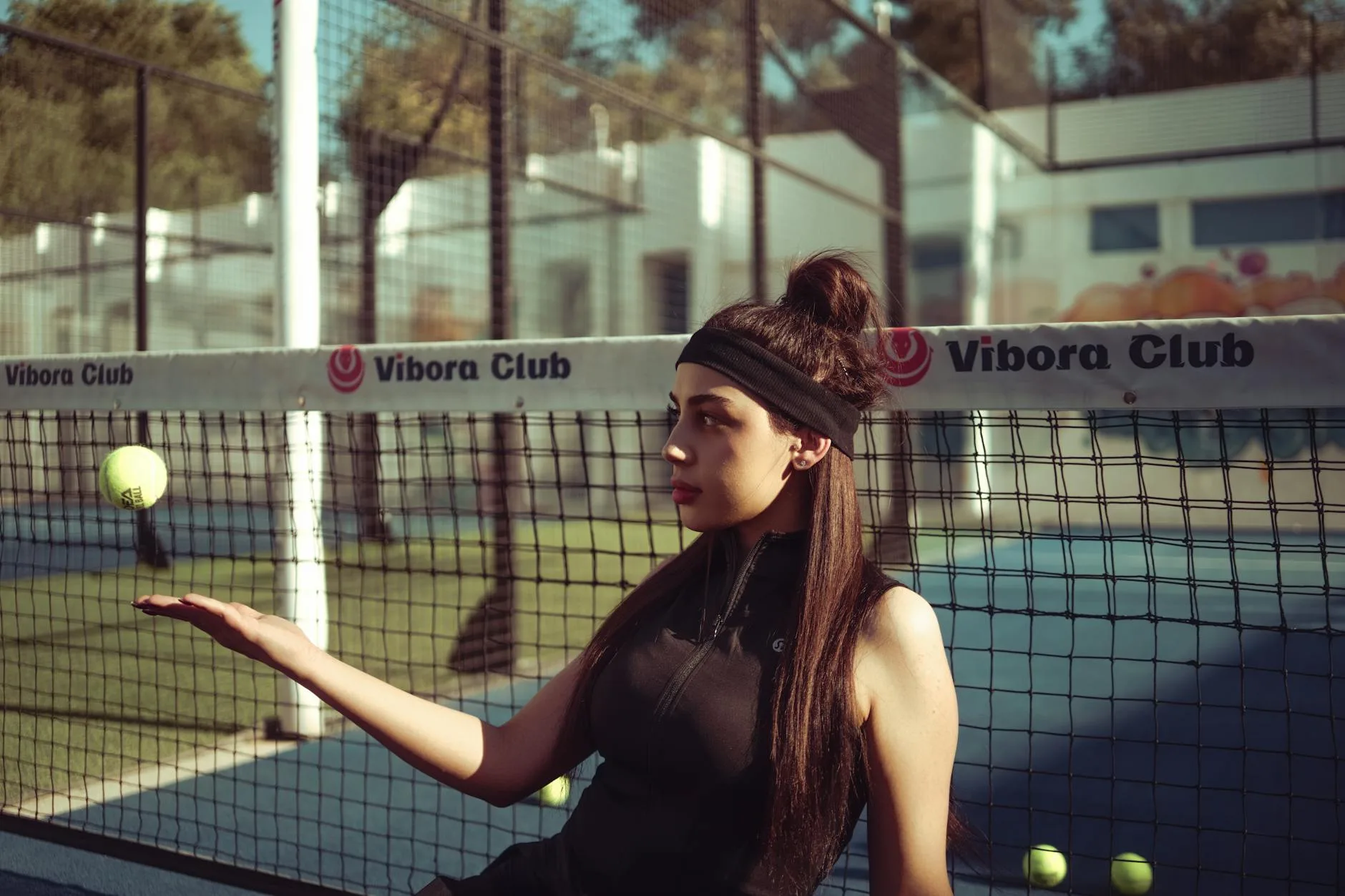Padel player hitting a volley at the net during a match