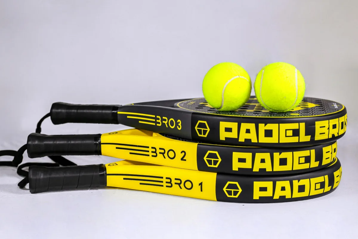Padel rackets and balls displayed on a white background