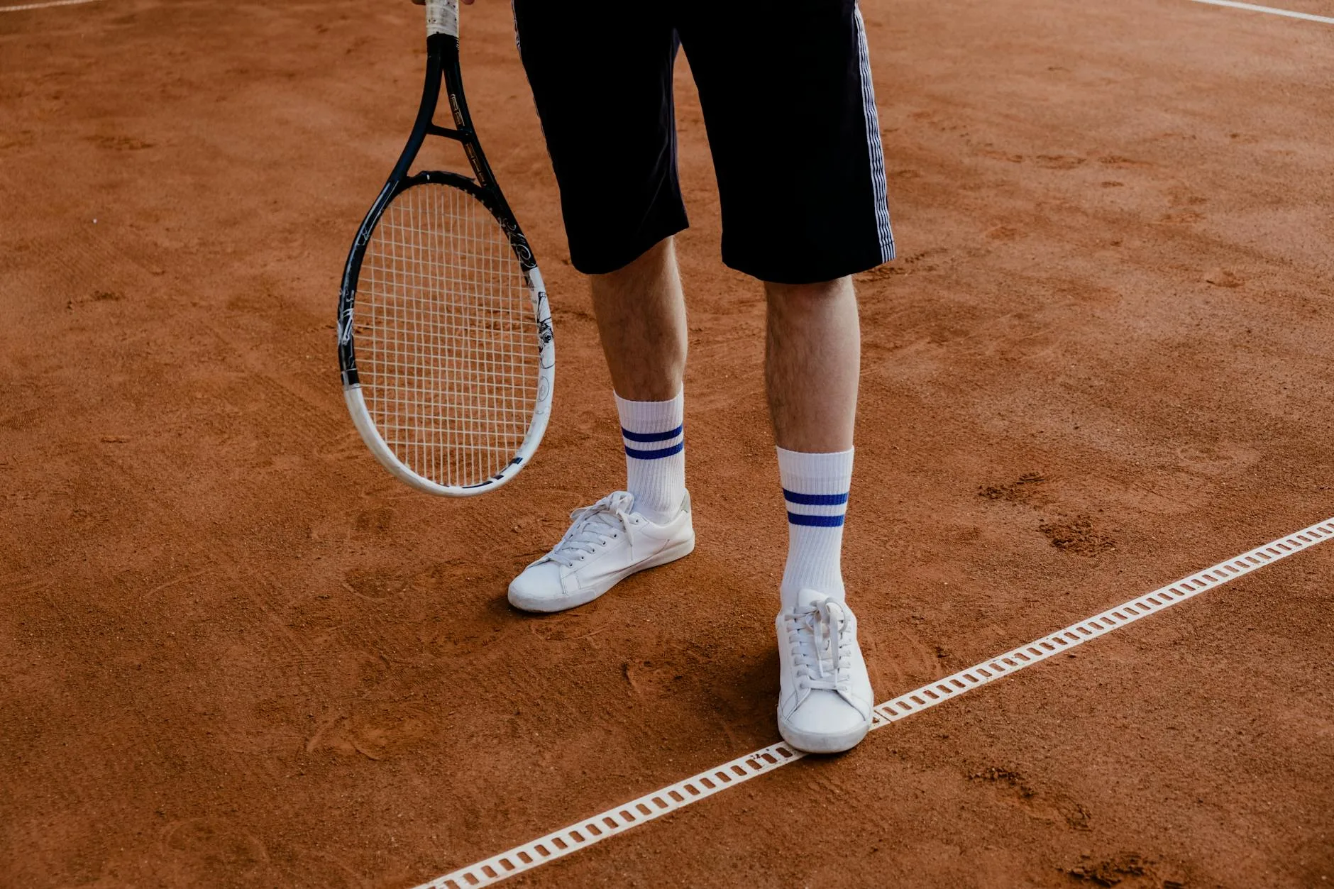 Sport shoes on court surface during racket sport game