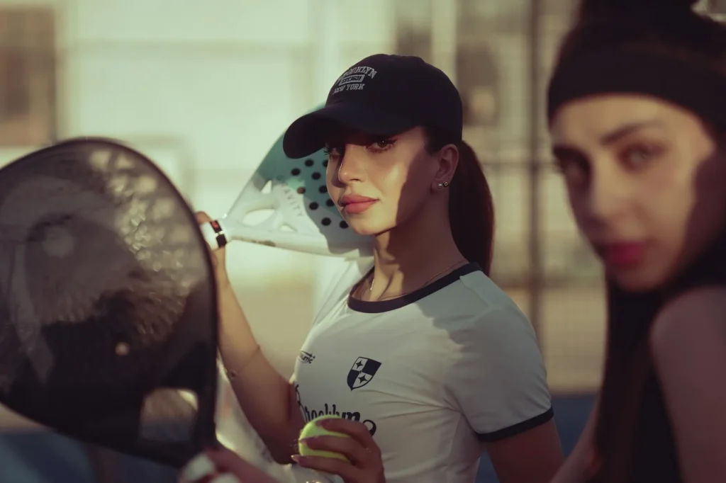 Professional padel match on glass-walled court