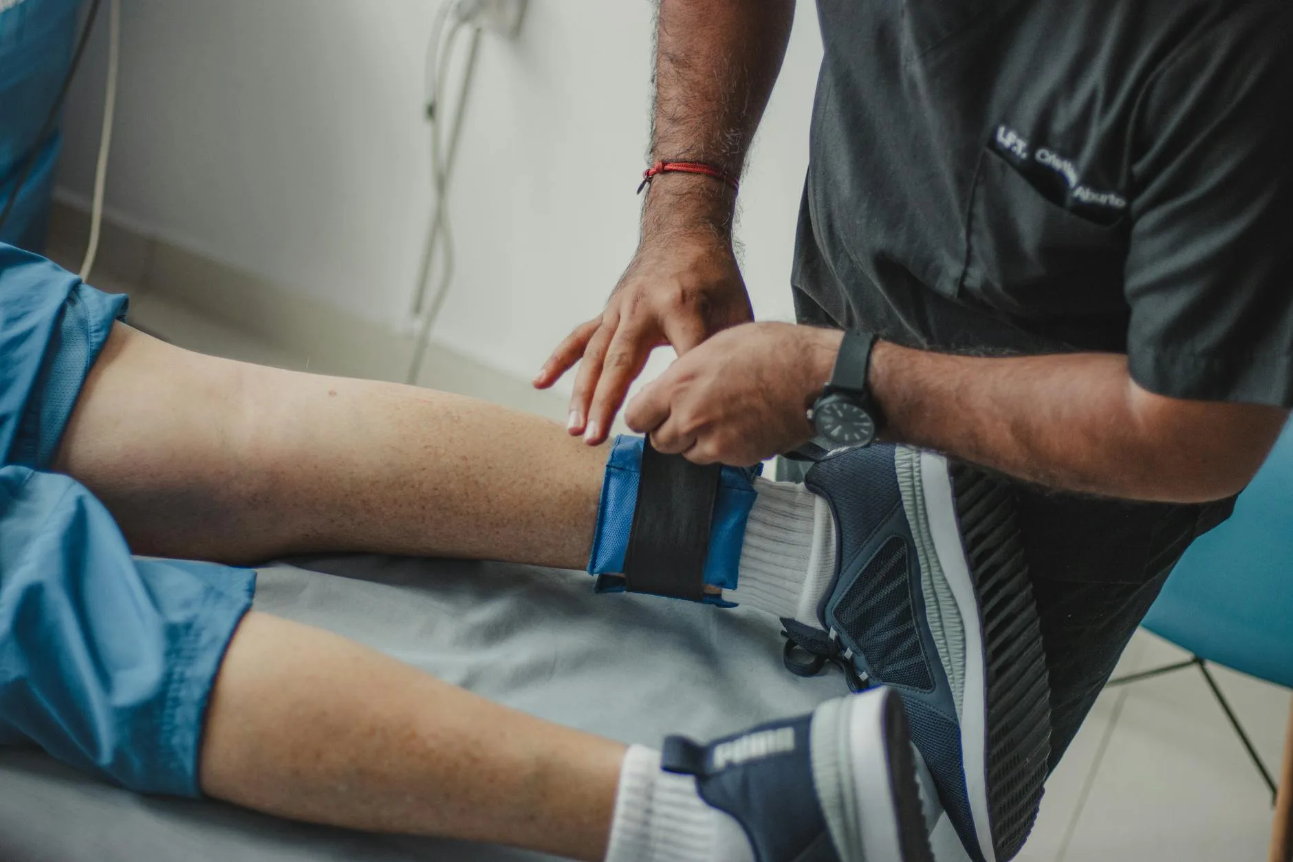 Athlete treating ankle injury with ice pack after sport