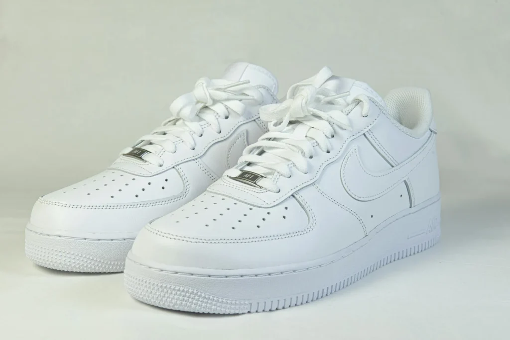Clean white sports trainers on a flat surface