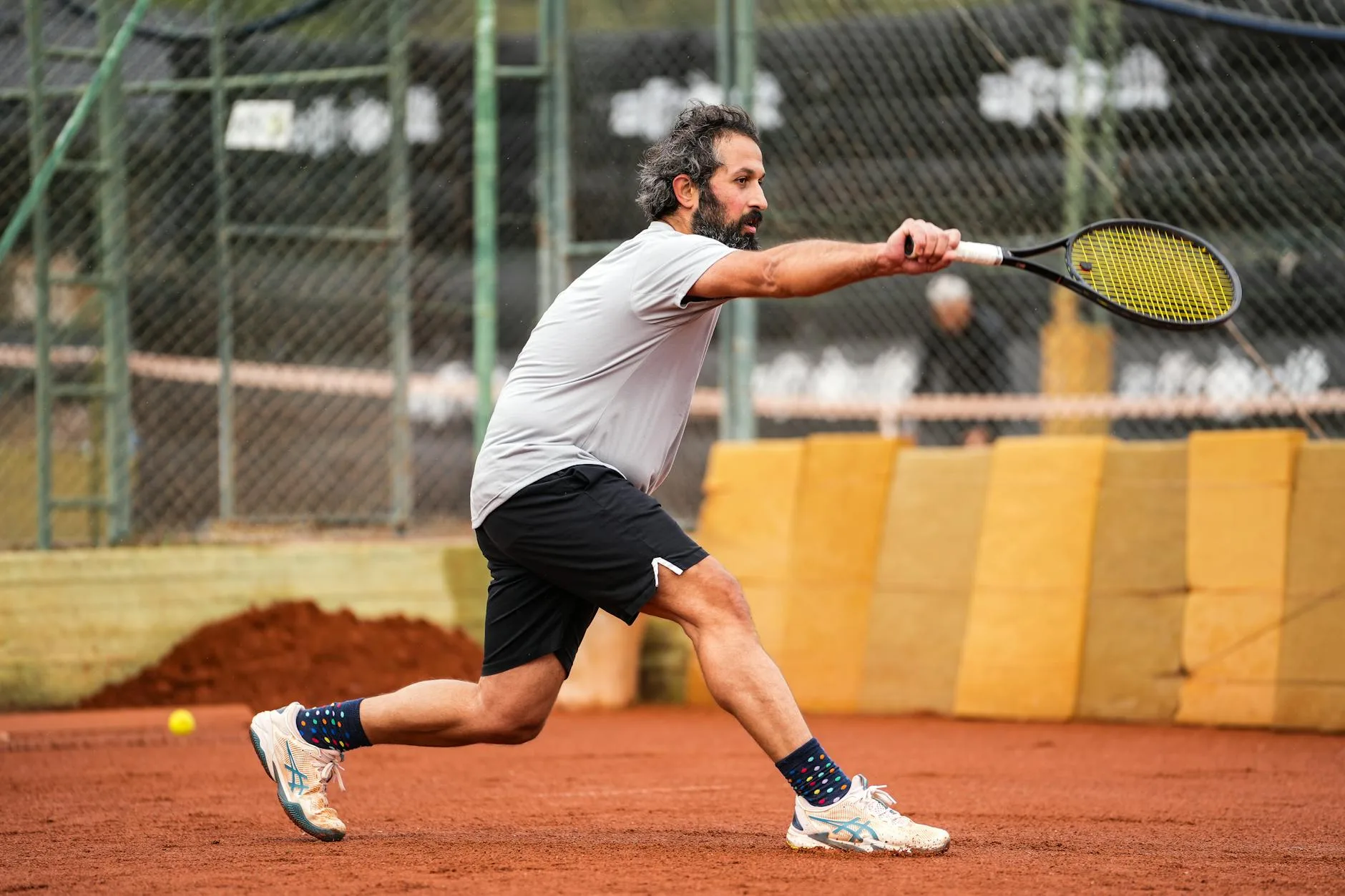 Padel player preparing a lob shot on court