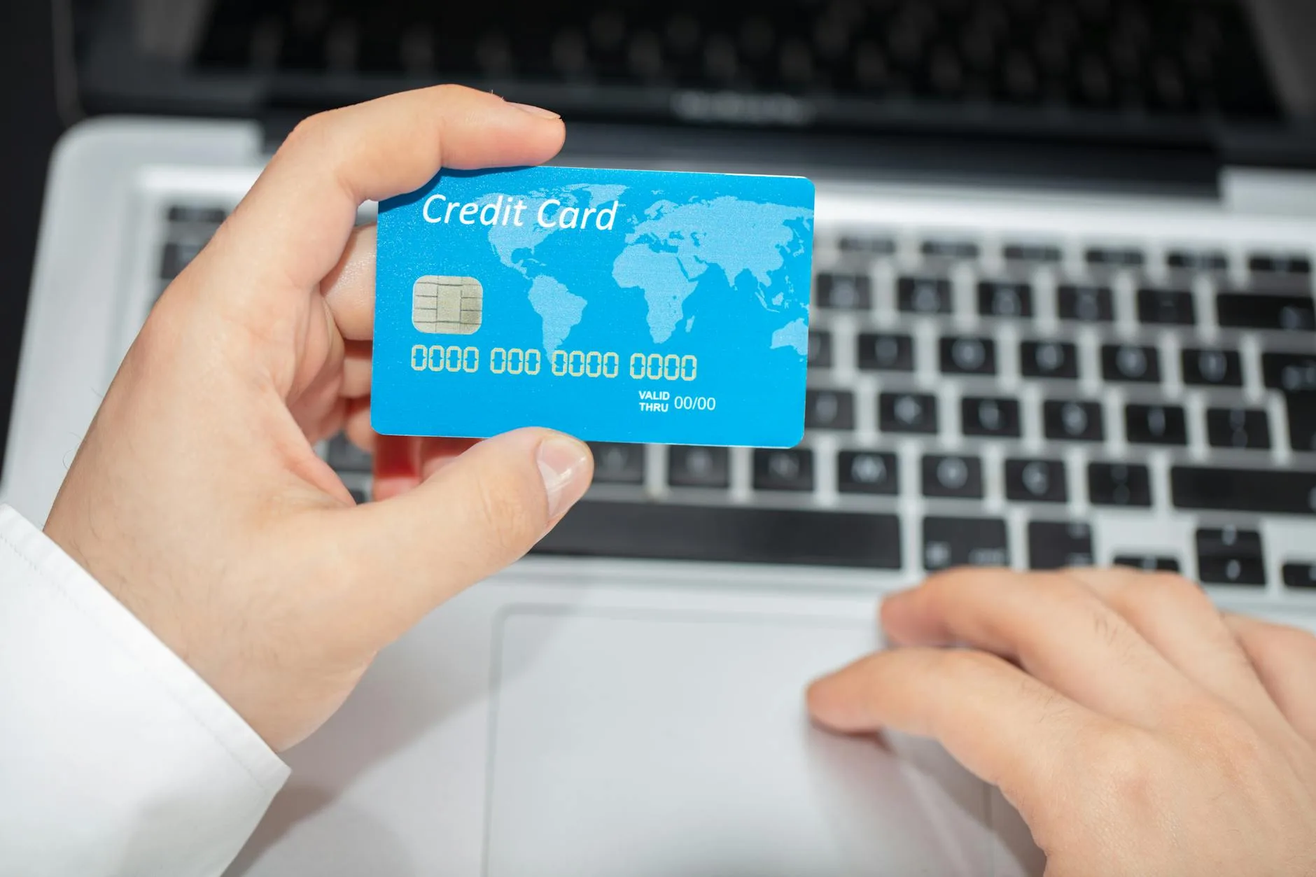 Person holding a credit card while shopping online for sports equipment
