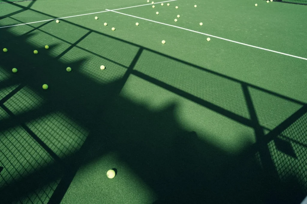 Padel player with racket on an enclosed glass court