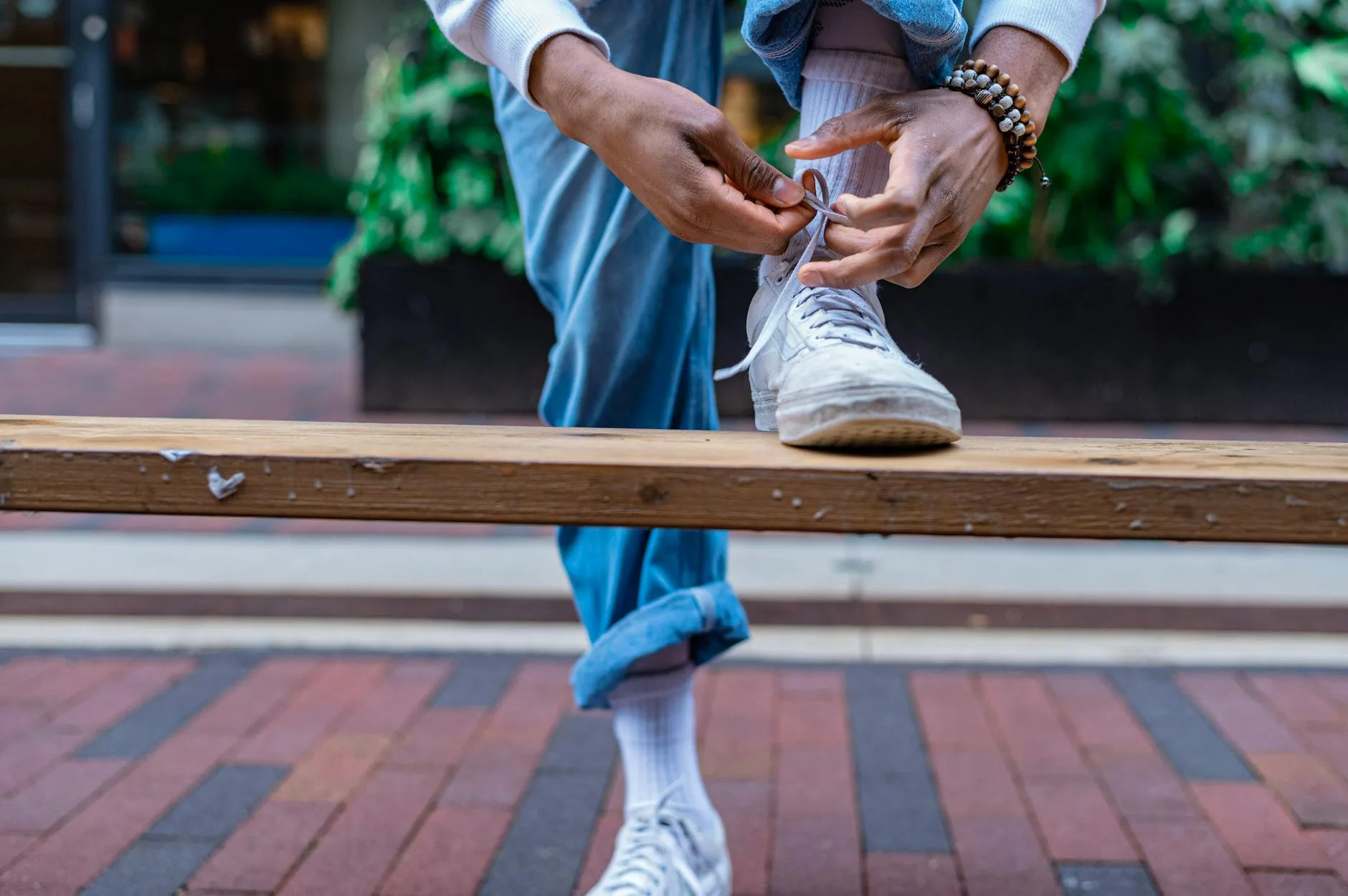 Person lacing up athletic shoes before a sports session