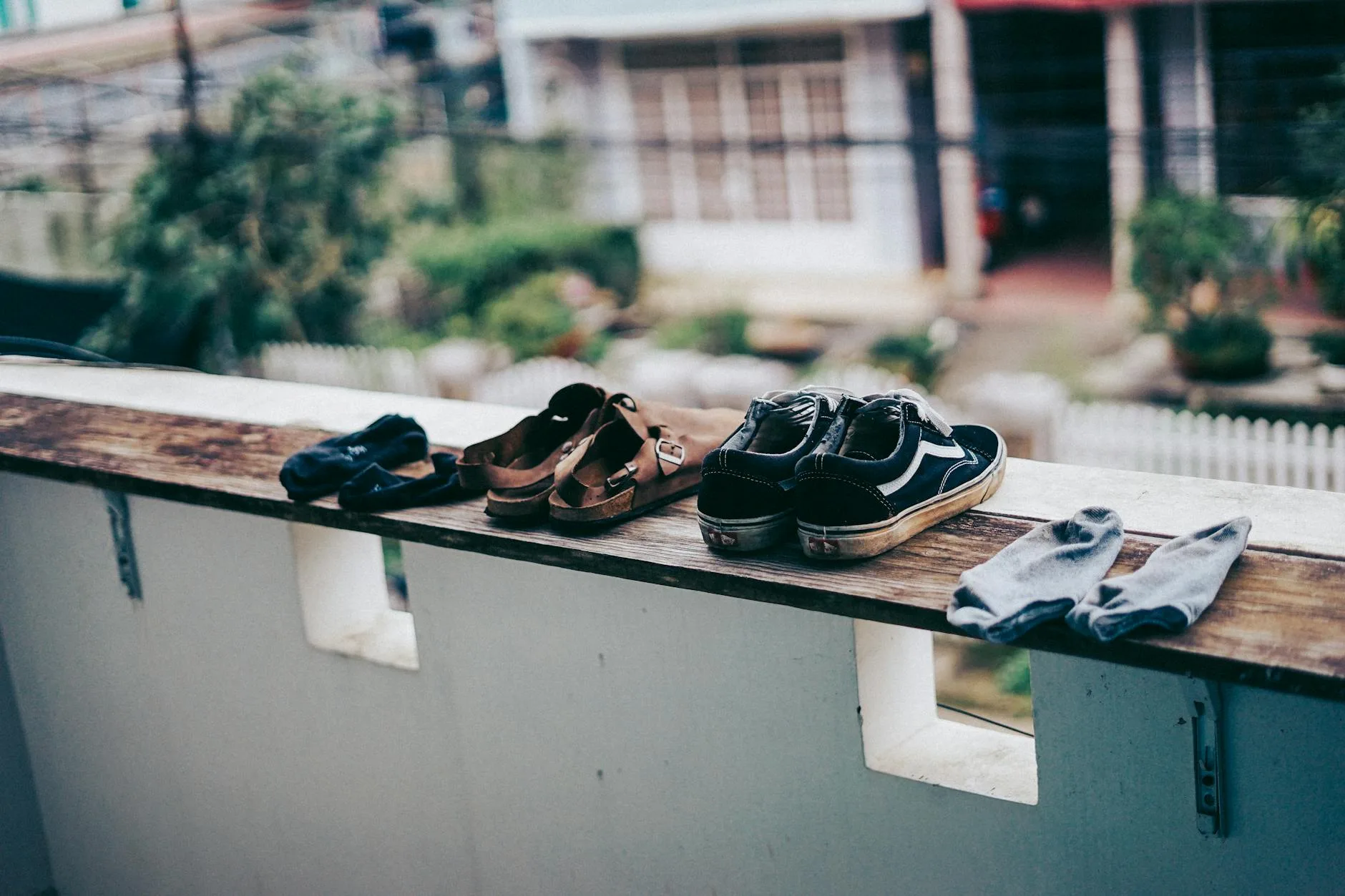 Sports shoes drying on a ledge outdoors