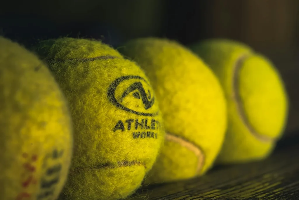 Yellow sports ball on a court surface close-up