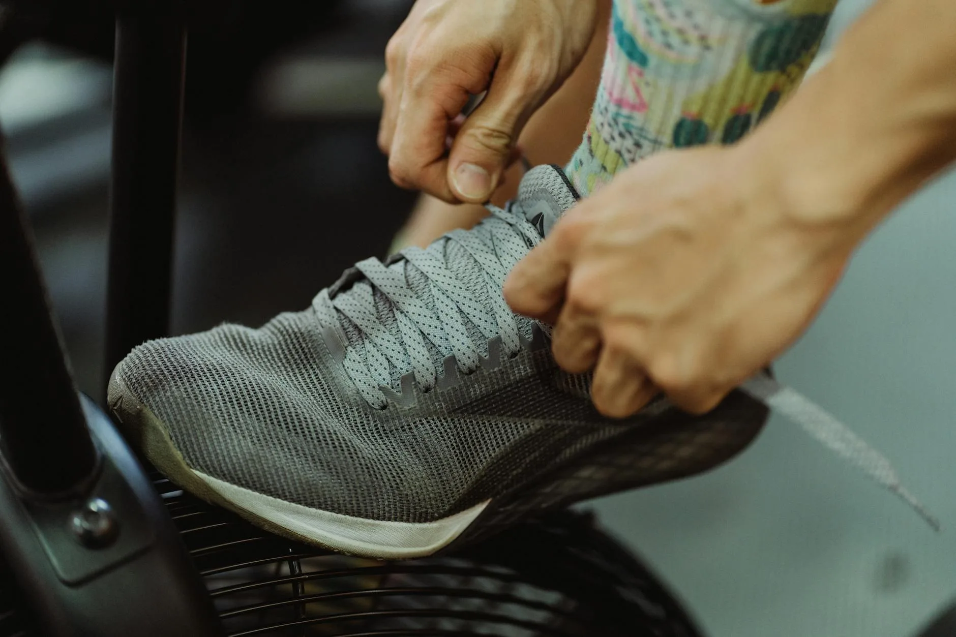 Person tying sport shoe laces before playing on court