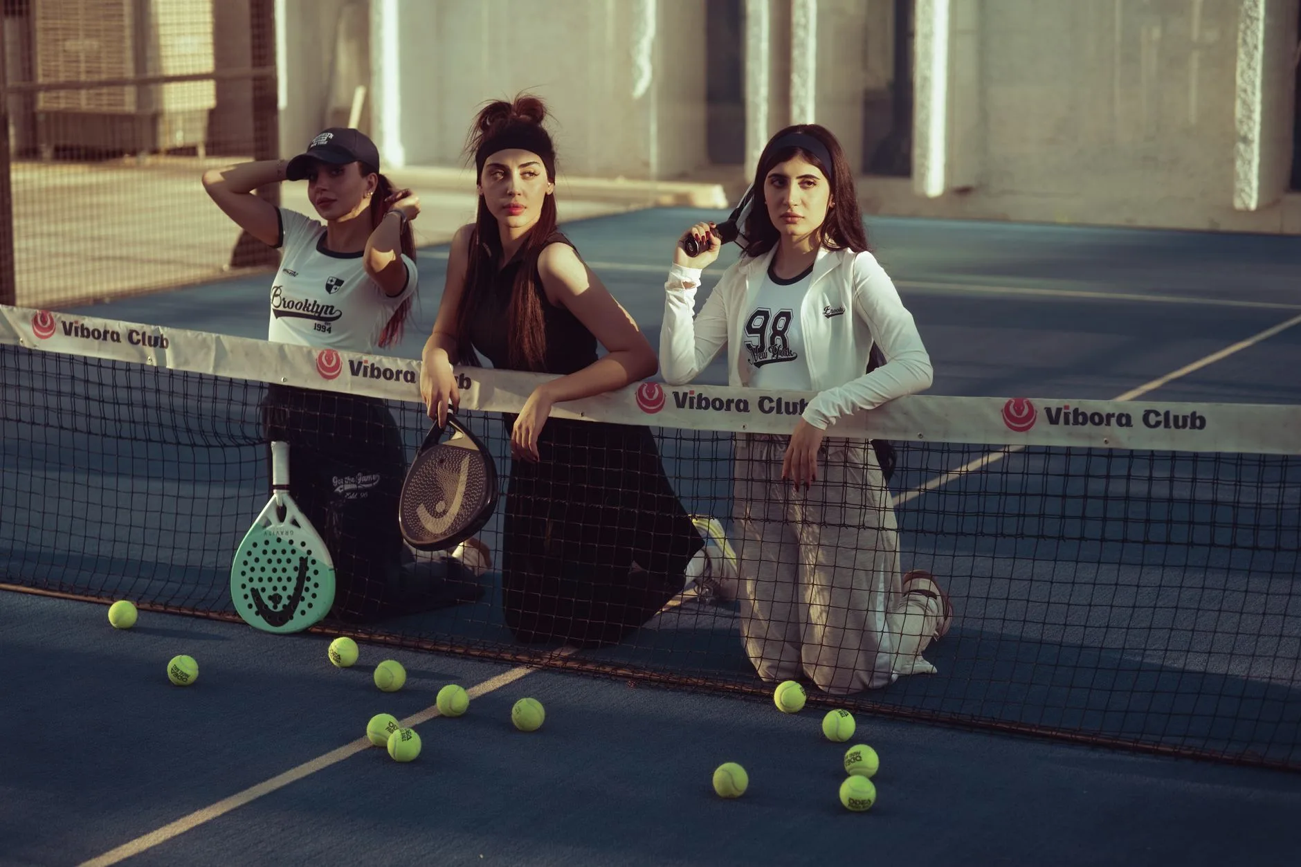 Padel players with solid rackets resetting near the net