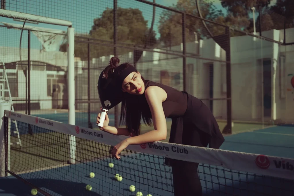 Padel players on a glass court for injury prevention advice