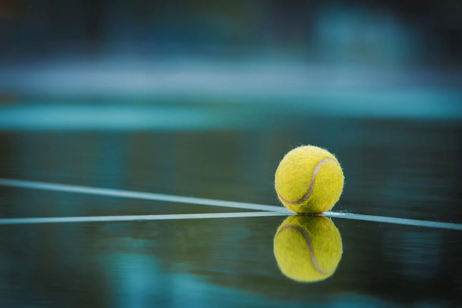 Padel ball on court surface for serve technique practice